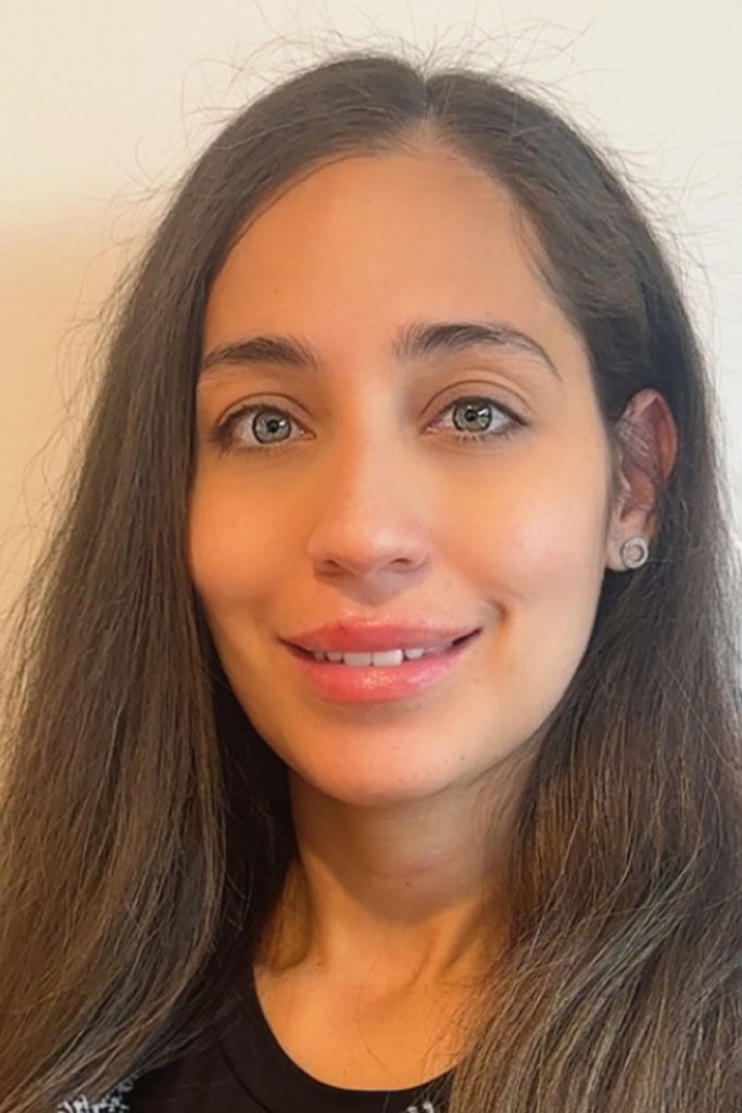 Headshot portrait of Destiny Matos, a smiling woman with long brown hair.