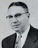 david panebaker, alumni of liberty and honoree of wall of fame, portrait, black and white, suit and tie, wearing glasses, facing camera