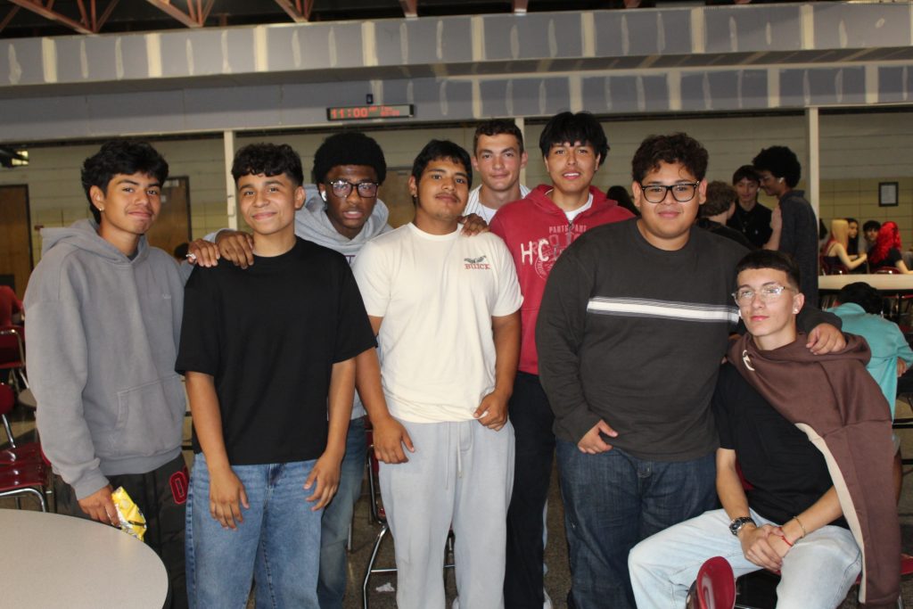 group of young high schoolers posing for the camera