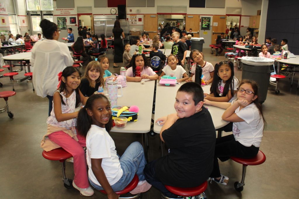 students gathered in the cafeteria for lunch