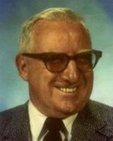 james burke, smiling, wearing suit and tie, and glasses, alumni of liberty and honoree of wall of fame