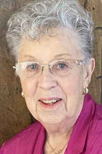 joyce teed, alumni of liberty and honoree of wall of fame, wearing glasses, short hair, smiling, wearing pink